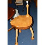 A NATURALISTIC HARDWOOD OCCASIONAL TABLE on triple legs with attached lamp