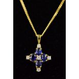 A MODERN SAPPHIRE AND DIAMOND CROSS SHAPE PENDANT, measuring 13.9mm in diameter, estimated total