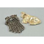 A SILVER BULL AND AN EARLY VICTORIAN STEEL COIN PURSE, the silver bull positioned laid down,