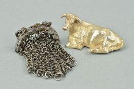 A SILVER BULL AND AN EARLY VICTORIAN STEEL COIN PURSE, the silver bull positioned laid down,