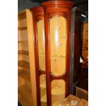 A TALL PAIR OF GLAZED SINGLE DOOR CORNER CUPBOARDS