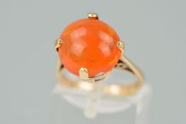 AN ORANGE PASTE RING, the circular orange paste within a four claw setting, stamped 9ct, ring size