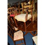 A NEAR SET OF SIX EDWARDIAN MAHOGANY FOLIATE CARVED LADDER BACK CHAIRS, with various upholstered