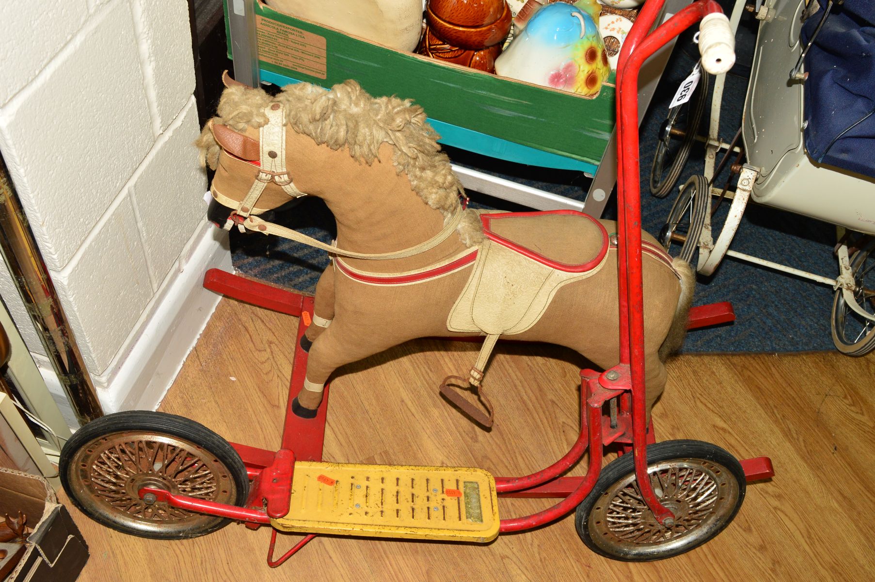 A WOODEN ROCKING HORSE, plush covered, fabric mane and tail, painted wooden mouth and hooves,