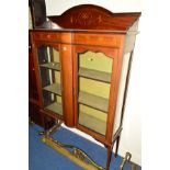 AN EDWARDIAN MAHOGANY AND INLAID GLAZED TWO DOOR DISPLAY CABINET with a raised back, central bow