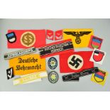 A NUMBER OF GERMAN 3RD REICH WWII ERA CLOTH PATCHES, ARM BANDS, SHOULD TITLES, CUFF BANDS, etc, as