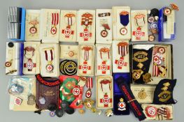 A LARGE BOX CONTAINING A LARGE NUMBER OF MEDALS, BADGES AND AWARDS TO VARIOUS MEMEBERS OF THE