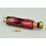A LATE 19TH CENTURY RED GLASS DOUBLE ENDED SCENT BOTTLE, the cylindrical shape with faceted