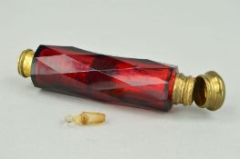 A LATE 19TH CENTURY RED GLASS DOUBLE ENDED SCENT BOTTLE, the cylindrical shape with faceted