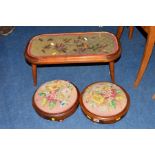 A PAIR OF VICTORIAN WALNUT FOOTSTOOLS with needlework upholstery and a mahogany occasional table (