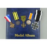 A LARGE MEDAL ALBUM, containing a number of WWI, WWII medals mainly original but also a number of