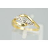 A 9CT GOLD DIAMOND DRESS RING, designed as three curved lines, the central line set with four single