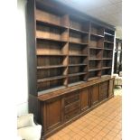 A LARGE LATE 19TH CENTURY WALNUT FOUR BAY OPEN BOOKCASE, with twenty adjustable shelves above a