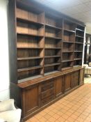 A LARGE LATE 19TH CENTURY WALNUT FOUR BAY OPEN BOOKCASE, with twenty adjustable shelves above a