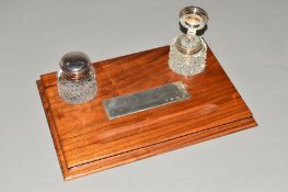 AN ELIZABETH II WALNUT DESK STAND, of rectangular form, moulded pen rest inset rectagular silver