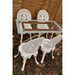 A GLASS TOPPED GARDEN TABLE ON A WHITE PAINTED ALUMINIUM STAND, together with a set of four