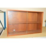 A SMALL TEAK BOOKCASE with one shelf and two glass sliding doors, circa 1970, approximate height
