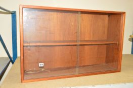 A SMALL TEAK BOOKCASE with one shelf and two glass sliding doors, circa 1970, approximate height