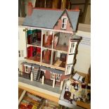 A VICTORIAN FOUR STOREY MODERN DOLLS HOUSE, fitted for electrics (not tested), with a quantity of