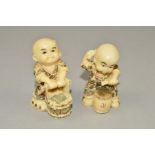 TWO RESIN NETSUKES, moulded as a boy drumming and a boy with a bucket, maximum height 4.5cm (2)