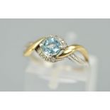 A SILVER TOPAZ AND DIAMOND DRESS RING, designed as a central circular blue topaz within a single cut