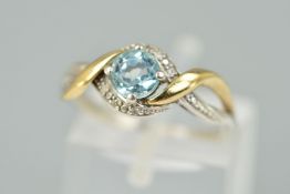 A SILVER TOPAZ AND DIAMOND DRESS RING, designed as a central circular blue topaz within a single cut