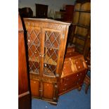 AN OAK FALL FRONT BUREAU above three drawers, together with an oak corner cabinet (2)