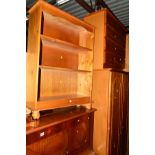 A PINE DOUBLE DOOR WARDROBE, a pine chest of four long drawers, a pine open bookcase, a boxed