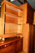 A PINE DOUBLE DOOR WARDROBE, a pine chest of four long drawers, a pine open bookcase, a boxed