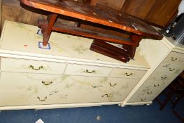 A LOW MODERN HEAVY CHEST OF THREE OVER FOUR DEEP DRAWERS, cream ground with painted floral and