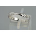 A 9CT WHITE GOLD DIAMOND DRESS RING, the band tapered inwards to the front and set to either side