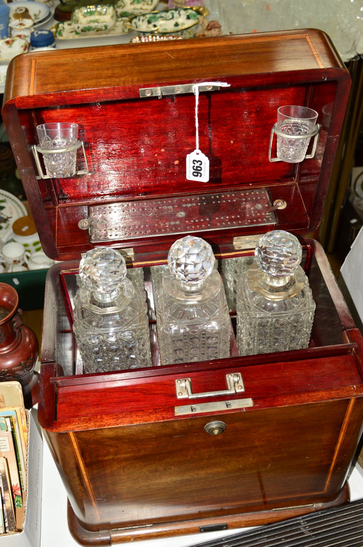 AN EDWARDIAN COMBINED TANTALUS AND GAMES COMPENDIUM TYPE INLAID BOX, fitted with three glass