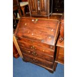 A GEORGIAN OAK FALL FRONT BUREAU revealing various fitments and drawers above three exterior