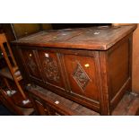 A REPRODUCTION OAK TRIPLE PANEL BLANKET CHEST