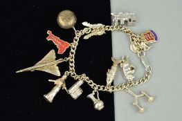 A SILVER CHARM BRACELET WITH THIRTEEN ASSORTED CHARMS to include a Concord and flexible fish,
