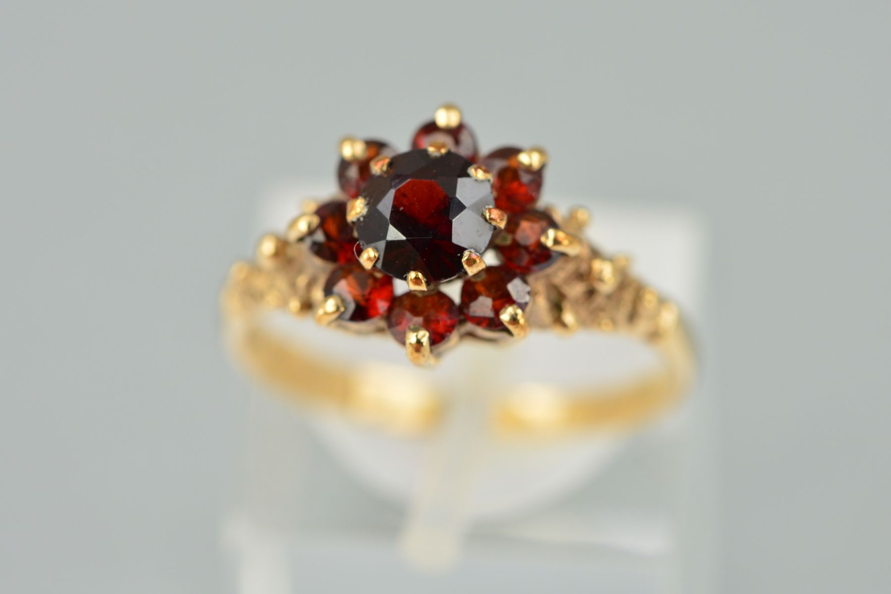 A 9CT GOLD GARNET CLUSTER RING, the central circular garnet within a tiered circular garnet surround - Image 2 of 2