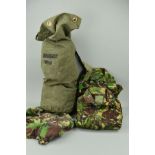 A GREEN CANVAS ARMY ISSUE BAG, containing four pairs of camo trousers, combat NATO DPM and four