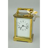 AN EARLY 20TH CENTURY BRASS CASED CARRIAGE CLOCK, white enamel dial, Roman numerals, fire glazed