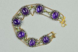 A GEM BRACELET, designed as an oval amethyst cabochons within scrolling rope twist surrounds flanked