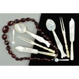 A FACETED RED PLASTIC BEAD NECKLACE AND MOTHER OF PEARL CUTLERY, the necklace comprising of