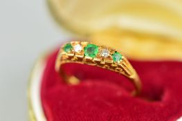 AN 18CT GOLD EMERALD AND DIAMOND RING, designed as three graduated circular emeralds interspaced
