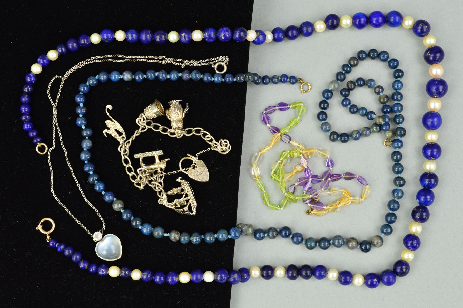 A COLLECTION OF JEWELLERY to include a silver bracelet with assorted charms, a lapis lazuli and