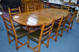 A REPRODUCTION TUDOR OAK OVAL TOPPED EXTENDING DINING TABLE on a cross stretchered base, with