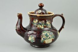A MEASHAM BARGEWARE TREACLE GLAZED TEAPOT, with applied floral baskets and vines, height
