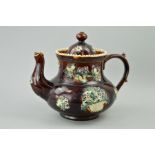 A MEASHAM BARGEWARE TREACLE GLAZED TEAPOT, with applied floral baskets and vines, height