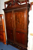 AN EDWARDIAN MAHOGANY DOUBLE DOOR WARDROBE with two short drawers and scrolled cornice, width