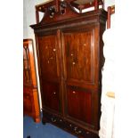 AN EDWARDIAN MAHOGANY DOUBLE DOOR WARDROBE with two short drawers and scrolled cornice, width