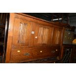 AN OAK LINENFOLD BLANKET BOX with a single drawer, together with a mahogany corner cabinet and a