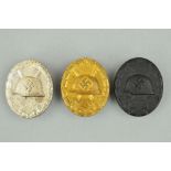 THREE GERMAN 3RD REICH WWII WOUND BADGES, black grade, un-marked, a boxed red, silver grade solid '