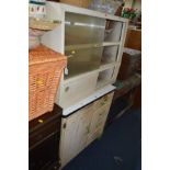 AN ENAMEL TOPPED KITCHEN CABINET flanked by four drawers and a seperate similar glass front